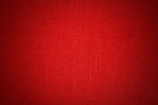 Dark red linen fabric cloth texture for background, natural textile pattern.