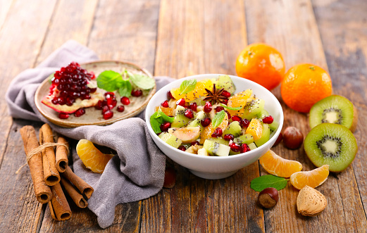 Variety of healthy smoothie bowls with ingredients on the kitchen counter. Top view of different types of fruit smoothie bowls served on table.