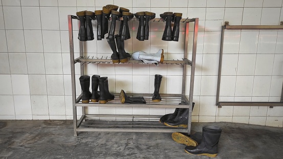 Industrial background of boots on the rack for factory workers to wear before going to production line for their safety