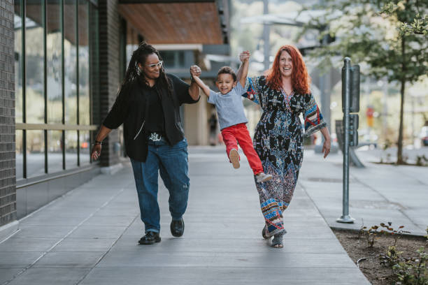 Happy family walking on city sidewalk