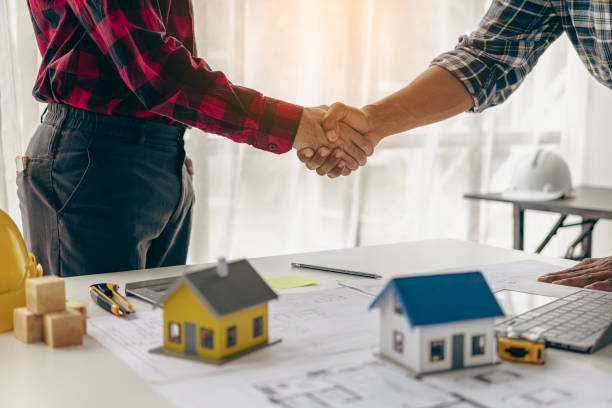 istock Construction worker and engineer holding hands Real estate concept: architect shaking hands with engineer or builder and successful meeting 1742206543