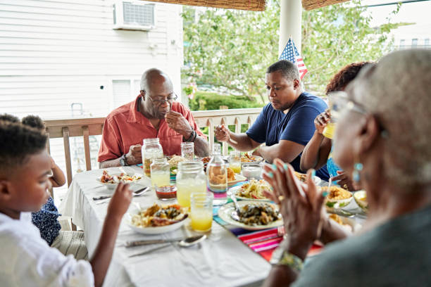 istock Three generations enjoying outdoor holiday meal 1742208633
