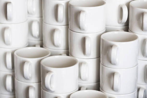 istock Coffee mugs stacked background. Ceramic mugs on white shelf. Coffee time background. 1742217960