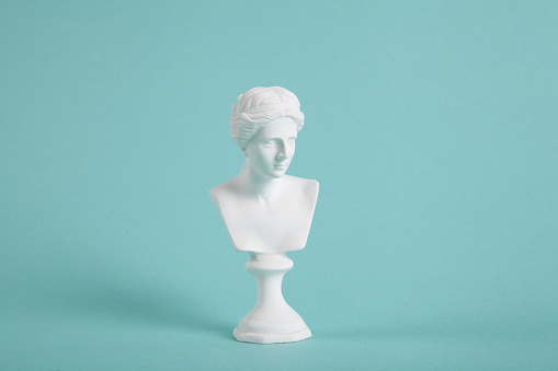 a white venus bust on a vivid turquoise background. A blend of classic and modern. Minimalist, trendy still life photography.