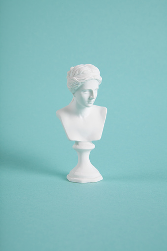 a white venus bust on a vivid turquoise background. A blend of classic and modern. Minimalist, trendy still life photography.
