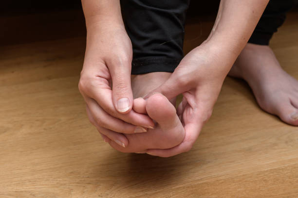 istock A woman touches and examines her foot 1742230032