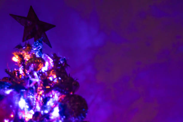 Christmas Tree on Neon Lighting Purple Background. Digitally generated image. 3d render.