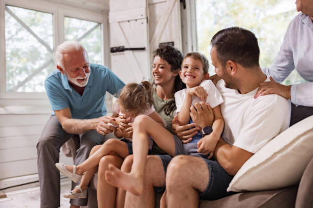 istock Playful extended family having fun on sofa at home. 1742242639