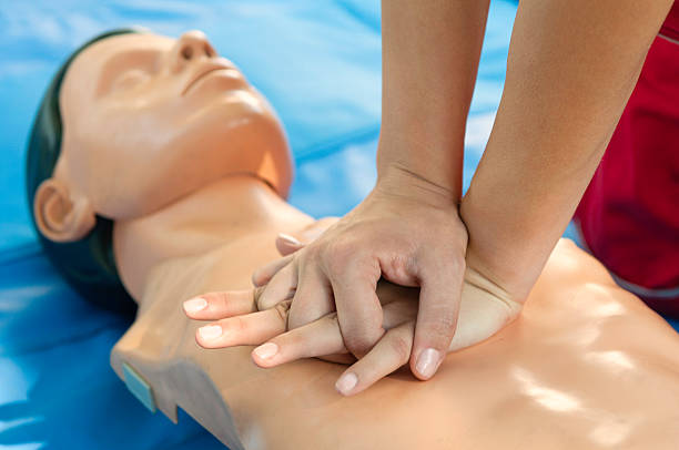 CPR chest compressions stock photo