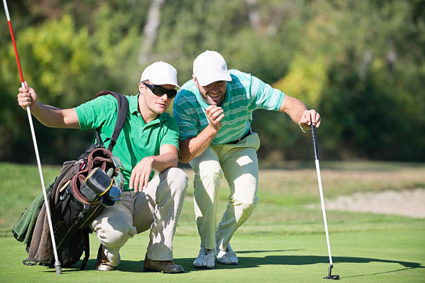 istock Golfer And Caddy Contemplating A Putting shot 174225412