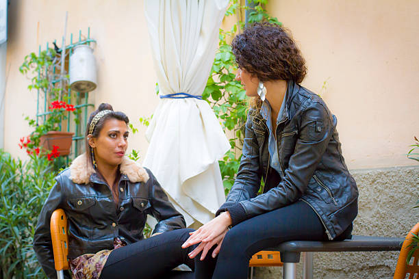Young women talking at bar
