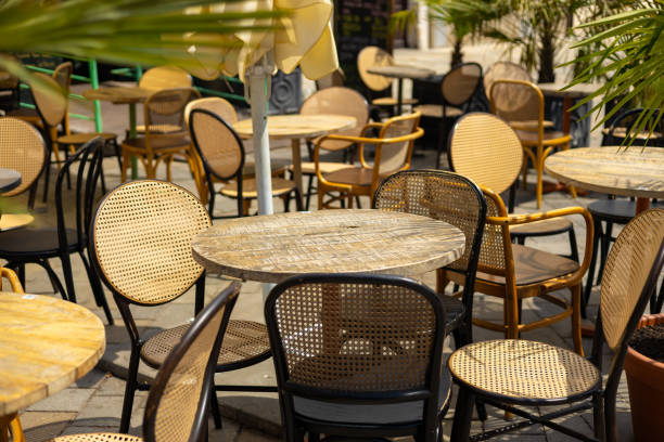 istock Empty restaurant summer terrace with tables and chairs. Reastaurant tables waiting for customers at an outdoor terrace, hipster style 1742262766