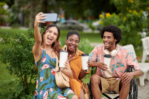 istock Man with Disability Photographing with Friends 1742270502