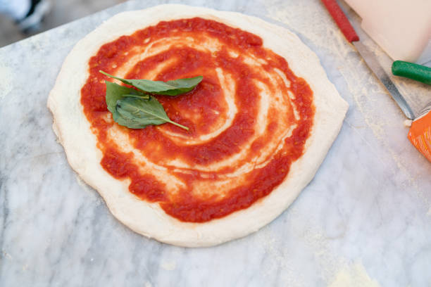 istock Pizza with tomato and basil ready to be baked. 1742277065