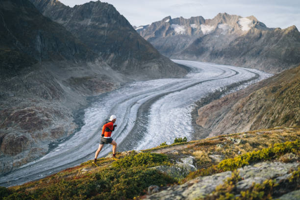 istock Senior male trail runner bounds along mountain trail 1742280304