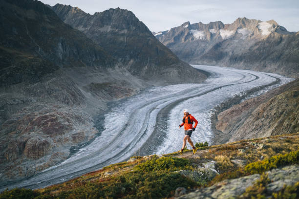 istock Senior male trail runner bounds along mountain trail 1742281950