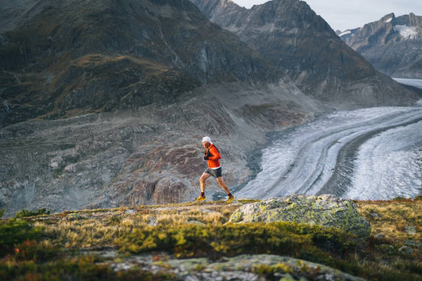 istock Senior male trail runner bounds along mountain trail 1742283550