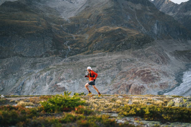 istock Senior male trail runner bounds along mountain trail 1742283702