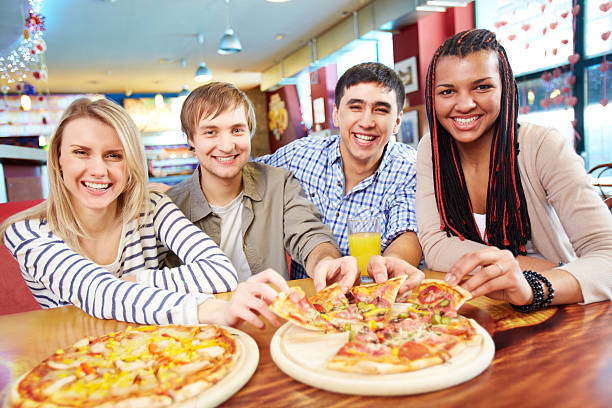 istock A group of friends sharing two pizza 174228439