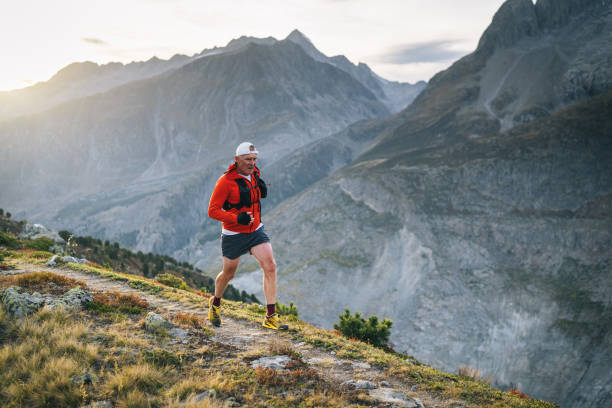 istock Senior male trail runner bounds along mountain trail 1742285724