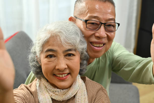 istock Affectionate happy old senior couple taking selfie and looking at camera 1742286305