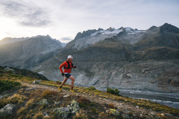 istock Senior male trail runner bounds along mountain trail 1742286689