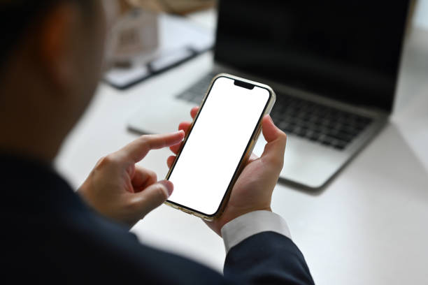 istock Over shoulder view of male manager using smartphone at desk 1742287453