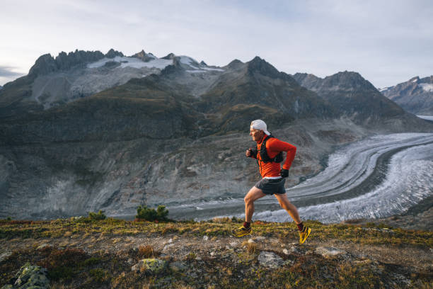 istock Senior male trail runner bounds along mountain trail 1742288660