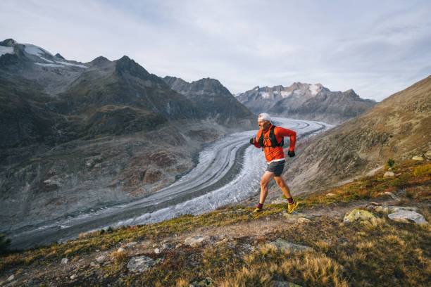 istock Senior male trail runner bounds along mountain trail 1742288661