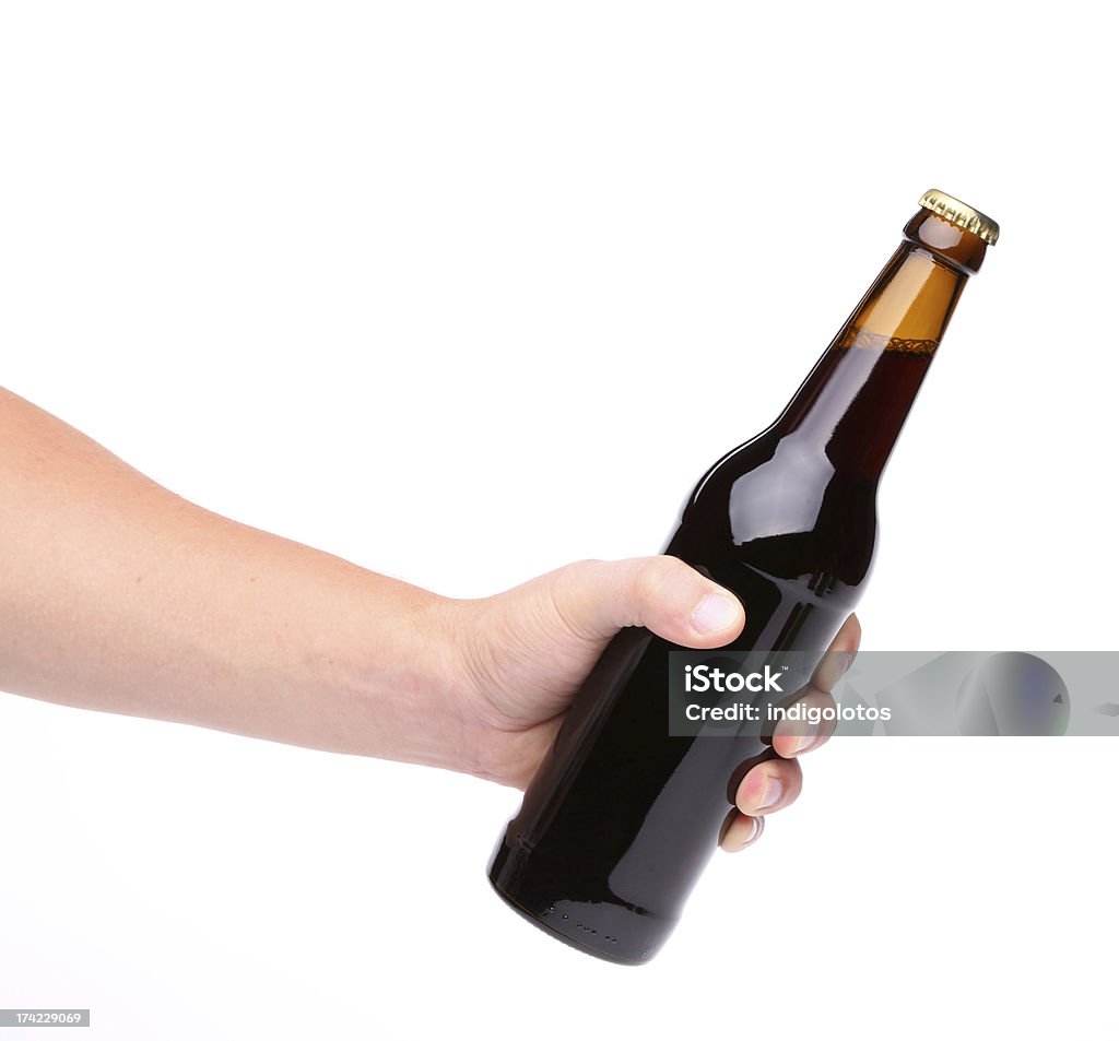 Beer bottle in the hand isolated on white Alcohol - Drink Stock Photo