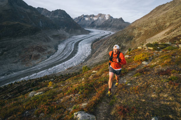 istock Senior male trail runner bounds along mountain trail 1742291340