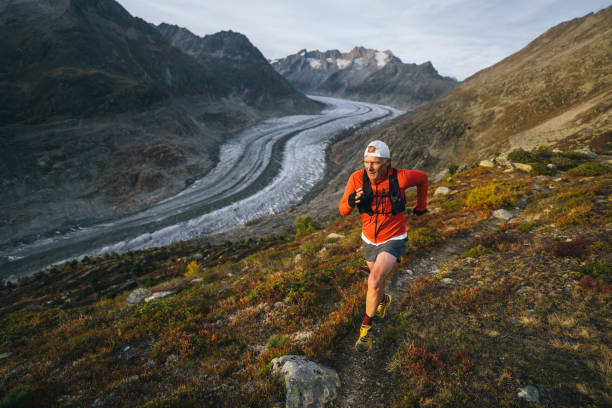 istock Senior male trail runner bounds along mountain trail 1742291859