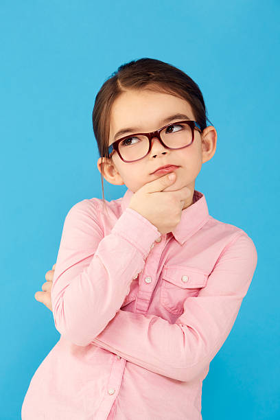 She'll figure it all out! A little girl holding her chin and looking up in a thoughtful expression preschooler caucasian one person part of stock pictures, royalty-free photos & images