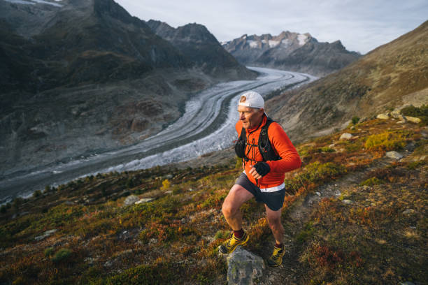 istock Senior male trail runner bounds along mountain trail 1742292422