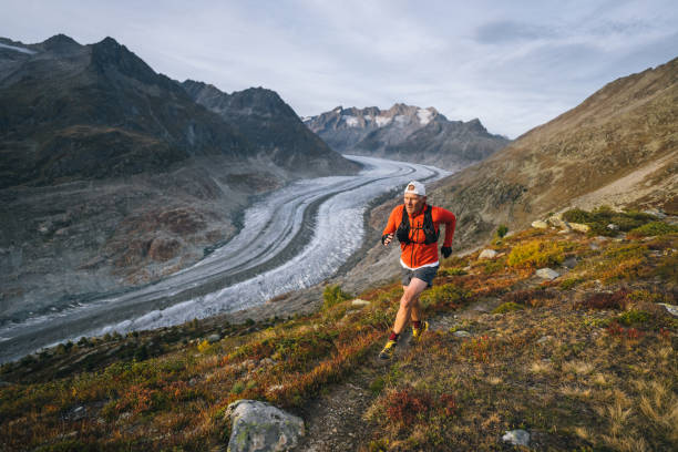 istock Senior male trail runner bounds along mountain trail 1742295206