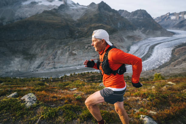istock Senior male trail runner bounds along mountain trail 1742295208