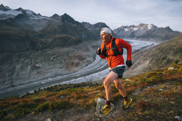 istock Senior male trail runner bounds along mountain trail 1742296882
