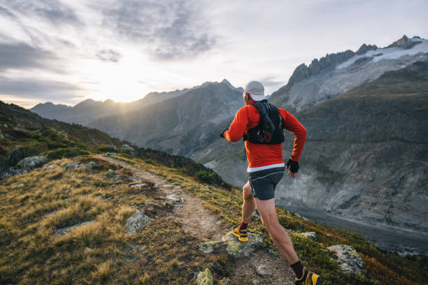 istock Senior male trail runner bounds along mountain trail 1742296885
