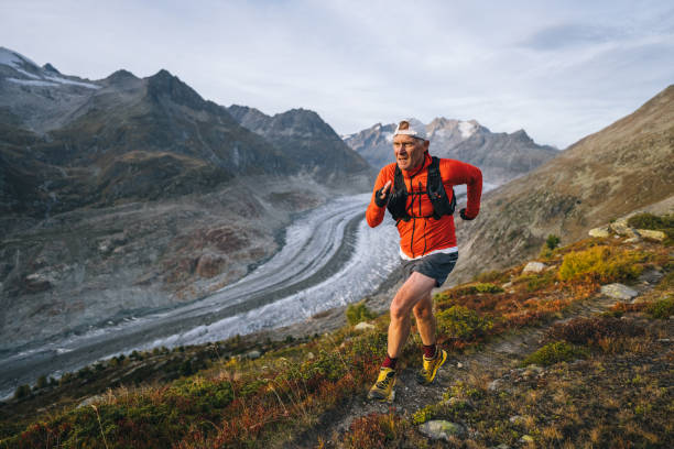 istock Senior male trail runner bounds along mountain trail 1742297430