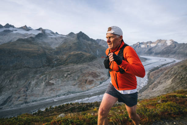 istock Senior male trail runner bounds along mountain trail 1742297433