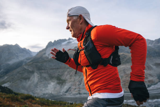 istock Senior male trail runner bounds along mountain trail 1742299689