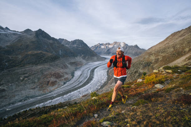 istock Senior male trail runner bounds along mountain trail 1742301977