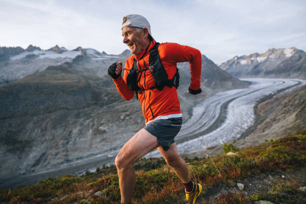 istock Senior male trail runner bounds along mountain trail 1742301995