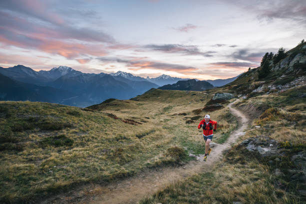 istock Senior male trail runner bounds along mountain trail 1742304335