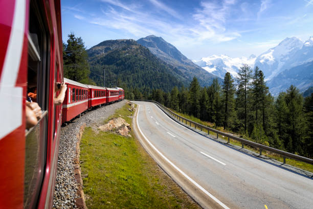 holidays in switzerland – bernina express train from st. moritz to bernina suot in the bernina range of the alps - bernina express imagens e fotografias de stock