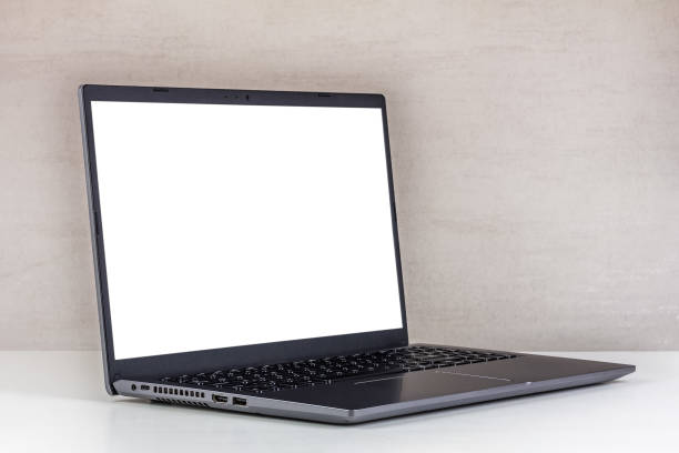 istock white mock-up on a laptop screen on a white table against a gray wall close-up 1742308648