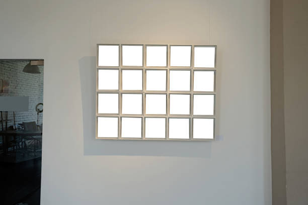 istock Blank picture frames on grey wall with glowing lamp, mock up 1742310290