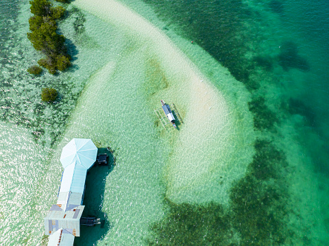 Transparent greenish water with boat and sandbar. Vanishing Island. Samal, Davao. Philippines.
