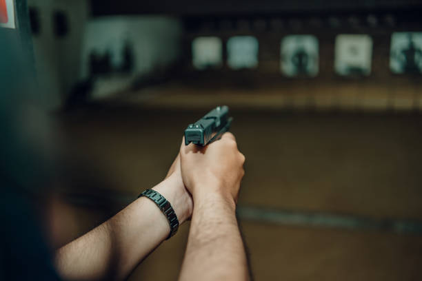 istock Professionals practice shooting a 9mm pistol inside a shooting range. 1742320723