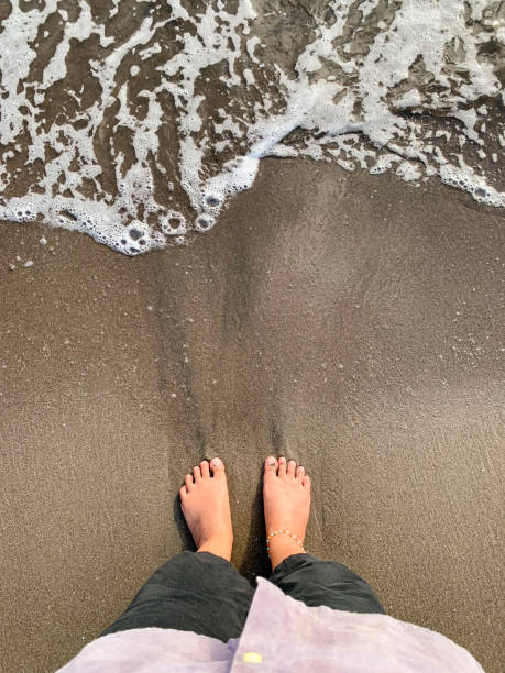 istock barefoot on the beach, grounding concept. 1742321944